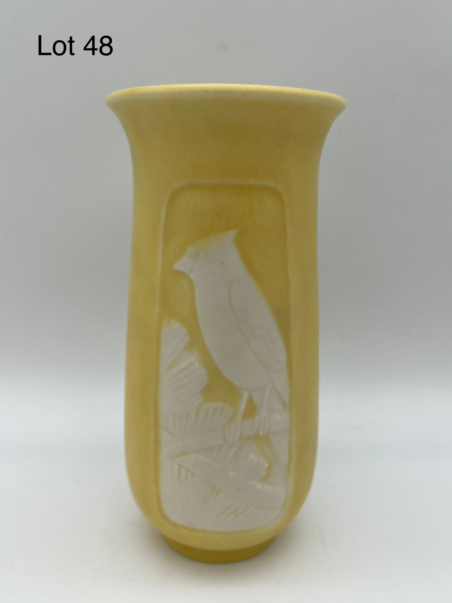 1935 Rookwood Embossed Three-Panel Cabinet Vase #6543: A vintage 1935 Rookwood cabinet vase in butter yellow glaze with three embossed nature scenes around the exterior done in intricate detail, featuring a perched cardinal. Makers marks underneath, mold 
