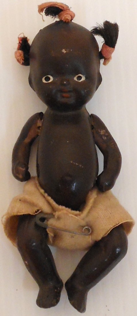Black Americana Porcelain Babydoll: 4 1/2", Vintage Black Babydoll with jointed arms legs and rooted hair made from jute and tied with cloth, all hand painted imported from Japan, circa 1930's, flannel diaper with safety pin, good condi