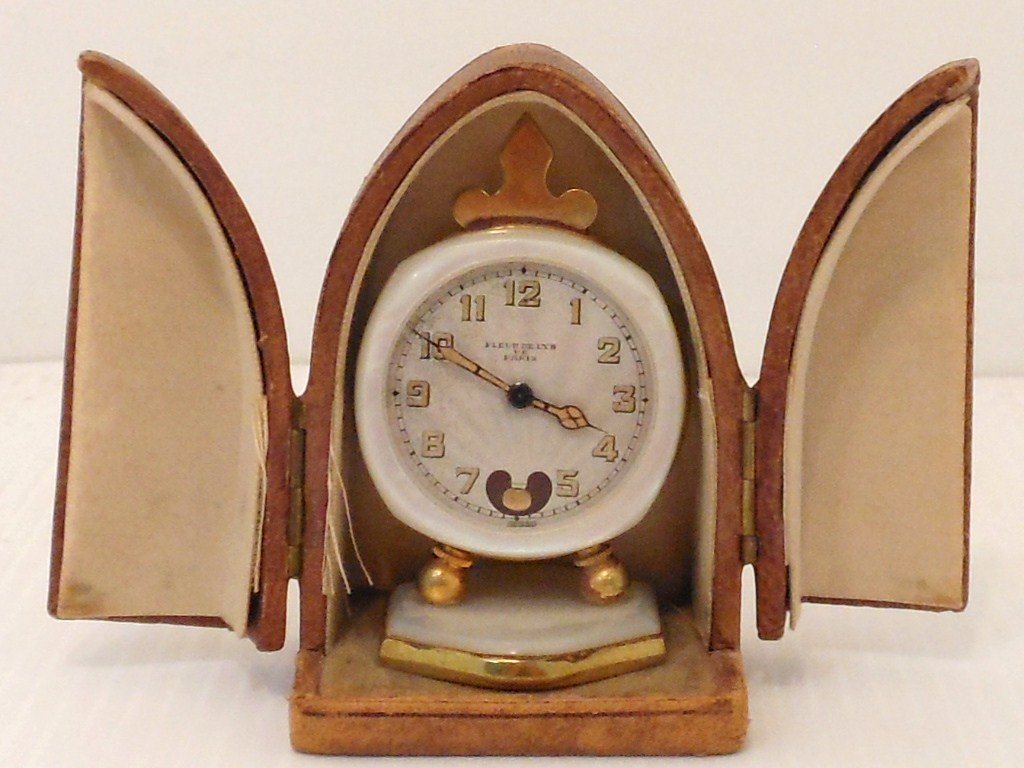Antique Fleur De Lys De Paris MOP Carriage Clock: 2 3/8" tall X 1 1/2" wide, antique Mother of Pearl and brass carriage clock in its original leather latched travel case, face is marked Fleur De Lys De Paris Swiss, bottom is marked Brevet 93017 Metal