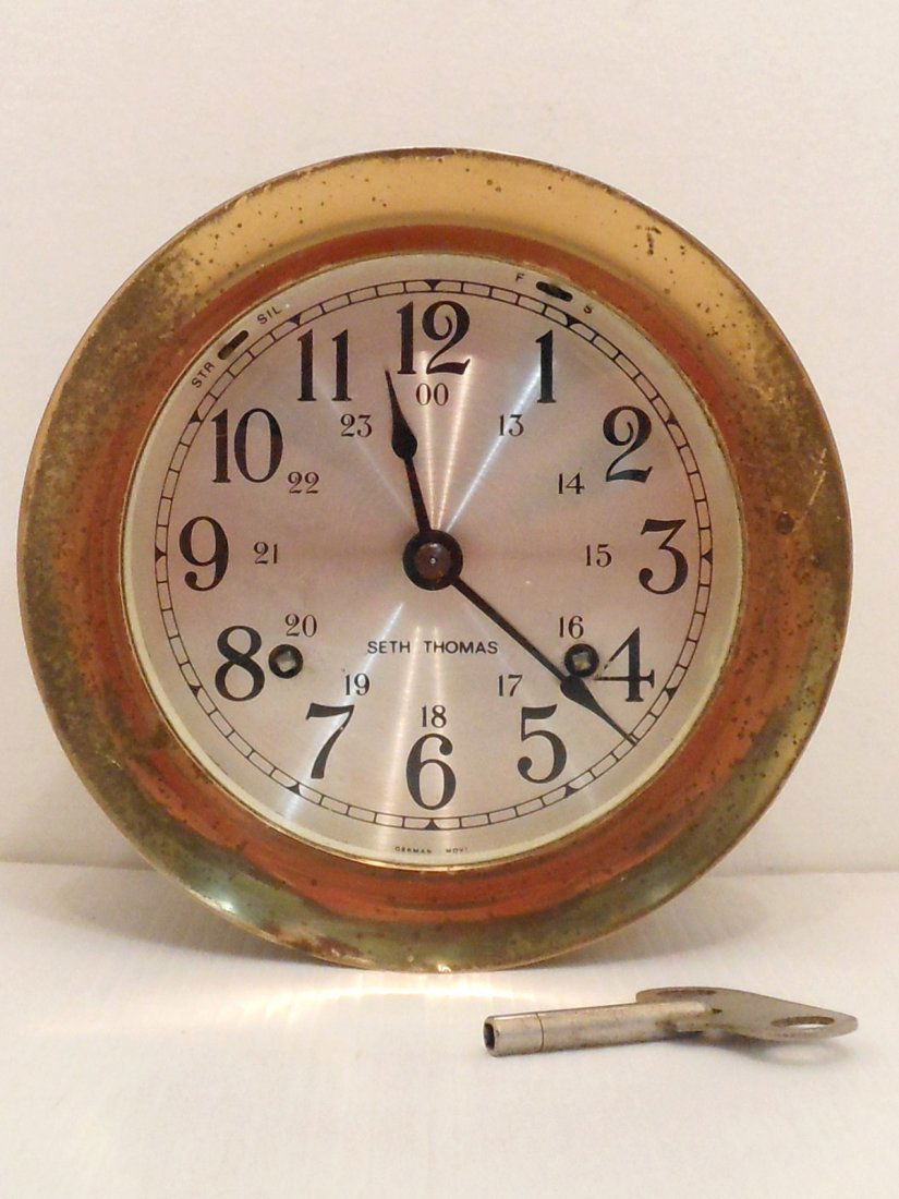 Seth Thomas Ship's Clock: 5 1/2" diameter X 3" deep, brass case that would be mounted on the wall, front rim and glass screw off to access key hole to wind, label on back Corsair ???-000, great working condition with some ding