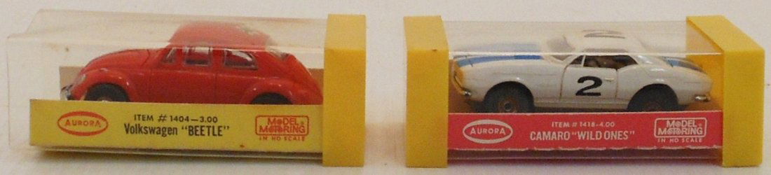 Pair of Aurora HO Model Motoring Cars #1: Volkswagen "Beetle" #1404-3.00. In case missing one end cap. Camaro "Wild Ones" in case. Both are in great used condition, tested and working, contacts were cleaned.