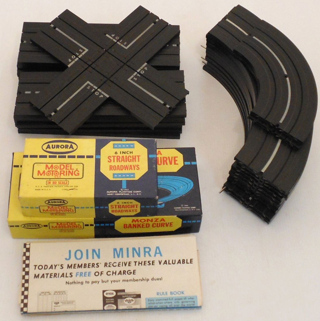 Aurora Model Motoring HO Scale Track: Lot of 42 sections of HO Scale Track, 13-9", 4-6"(in box) straight, 12-9' and 2-6" curve, Monza Banked Curve in box, one X intersection, a start, lap counter, 2 criss cross, and 2 squeeze tracks. Good