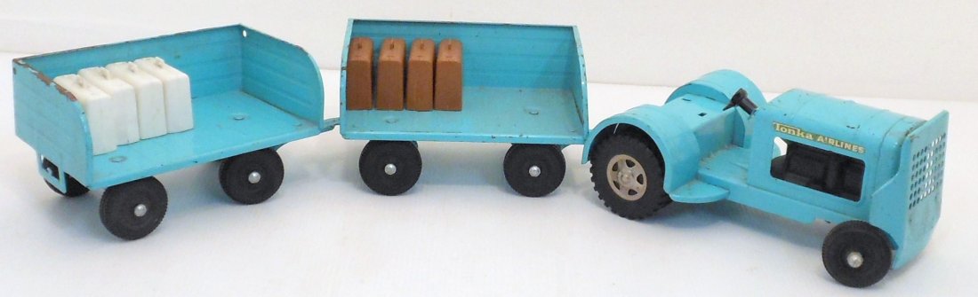 Vintage Tonka Airlines Tug and Carts with Luggage: Tug 8 1/2" long X 5 1/2" wide and carts 6 3/4" long X 4" wide, Aqua Tonka Airlines tug with 2 carts, 5 white and 4 brown suitcases, working condition with scrapes, scratches, paint loss and part of th
