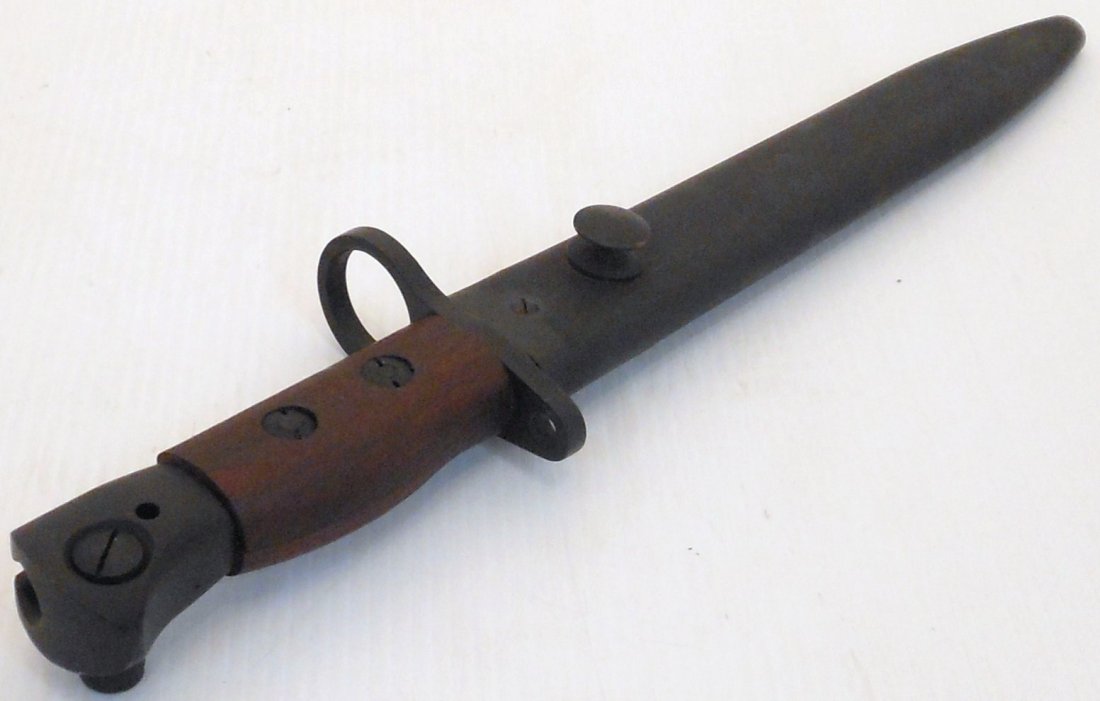 British #5 Enfield Jungle Carbine Bayonet Scabbard: 11 3/4" Total 7 3/4" blade and a 4" hilt, Bowie bladed Bayonet for the Enfield No.5 Jungle Carbine, marked P 194, wood grip, metal scabbard, great condition. May have residual from cleaning.