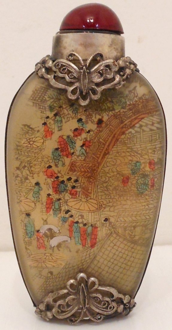 Reverse Painted Chinese Snuff Bottle: 3" tall X 1 1/2" wide X 3/4" thick, glass snuff bottle reverse painted with market scenes, metal frame decorated with butterflies and is marked, red cap, great condition.