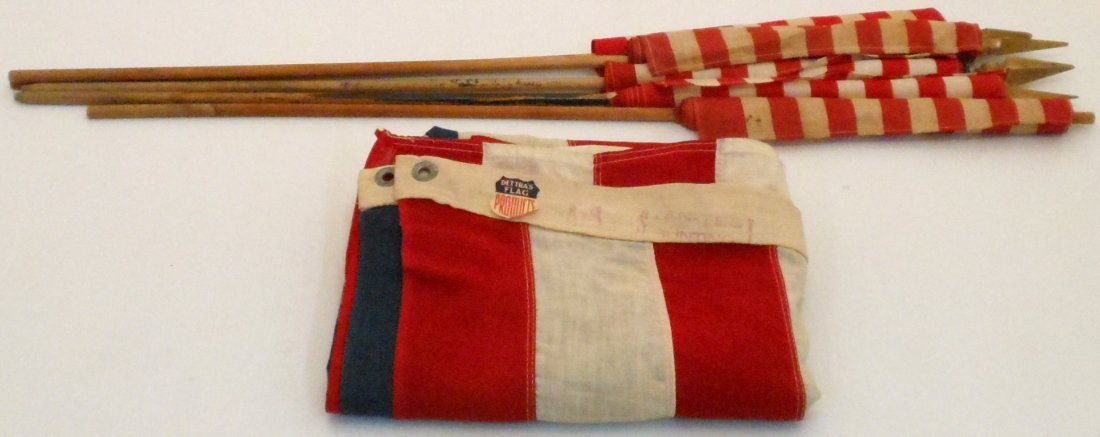 Lot of 48 Star American Flags and British Flag: Four vintage 11" X 16" 48 star flags on wooden sticks, two are in great condition two are in a fair condition, with fading and small holes. One British 11 X16" flag on a wooden stick in good condition