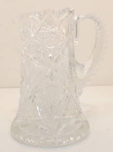 American Brilliant Cut Glass Pitcher: 8 12/" tall x 6" wide, thick and heavy American Brilliant Cut Glass Pitcher, deeply cut, flared base, full star on the bottom, applied cut handle. Excellent condition.