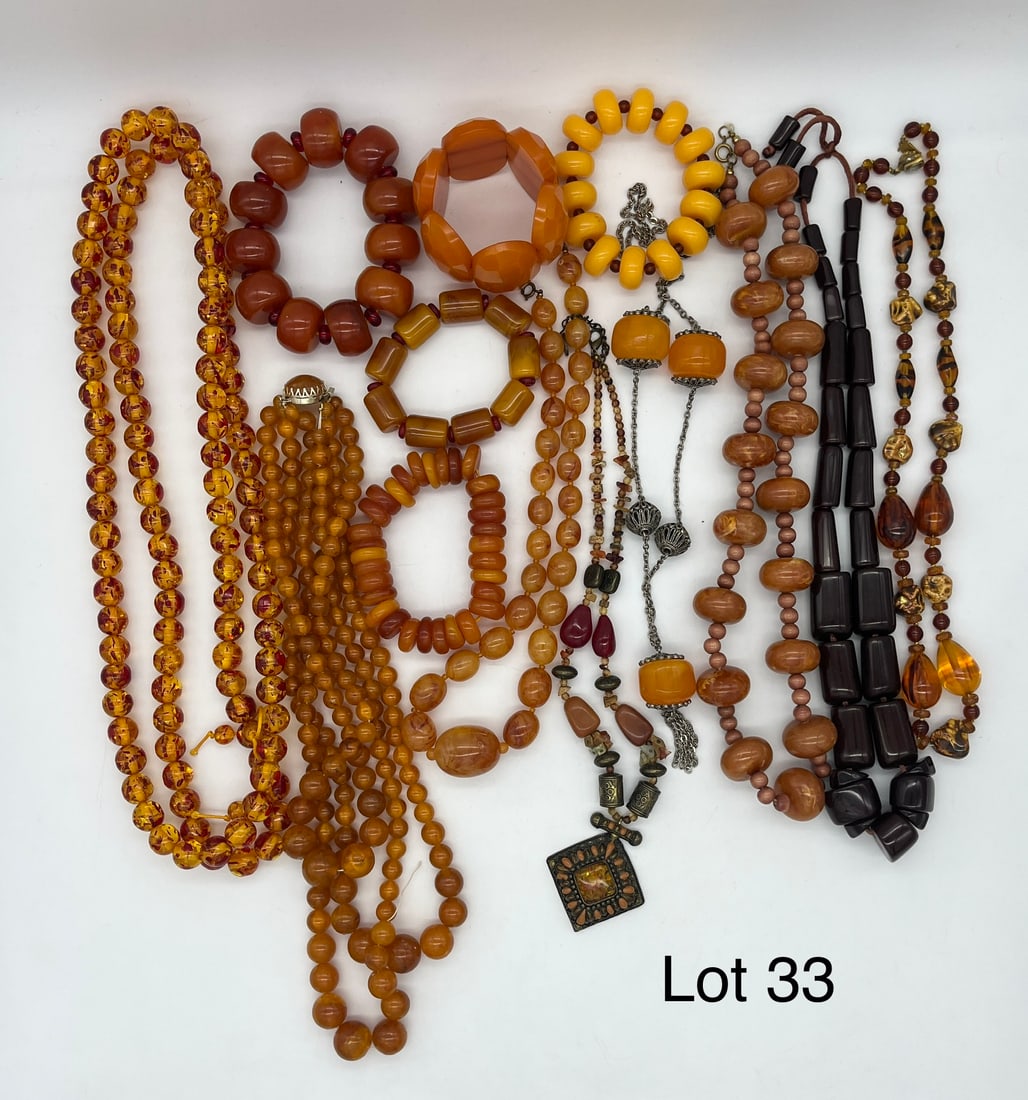 Lot of Amber Tone Costume Jewelry: A lot of beaded costume jewelry necklaces and bracelets in amber tones, showing both light and dark shades.
