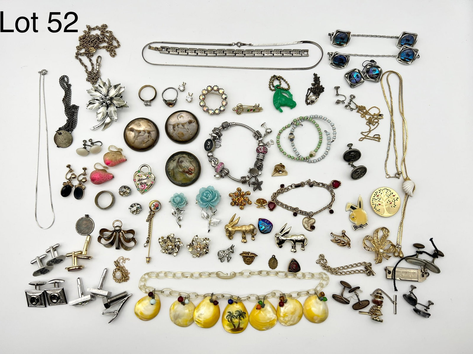 Selection of Costume Jewelry Including Vintage and Men's Accessories: Great variety of costume jewelry including many vintage pieces. Membership pins, several donkey pins, a playboy bunny pin, a Pandora style charm bracelet with charms, cufflinks and more are featured i