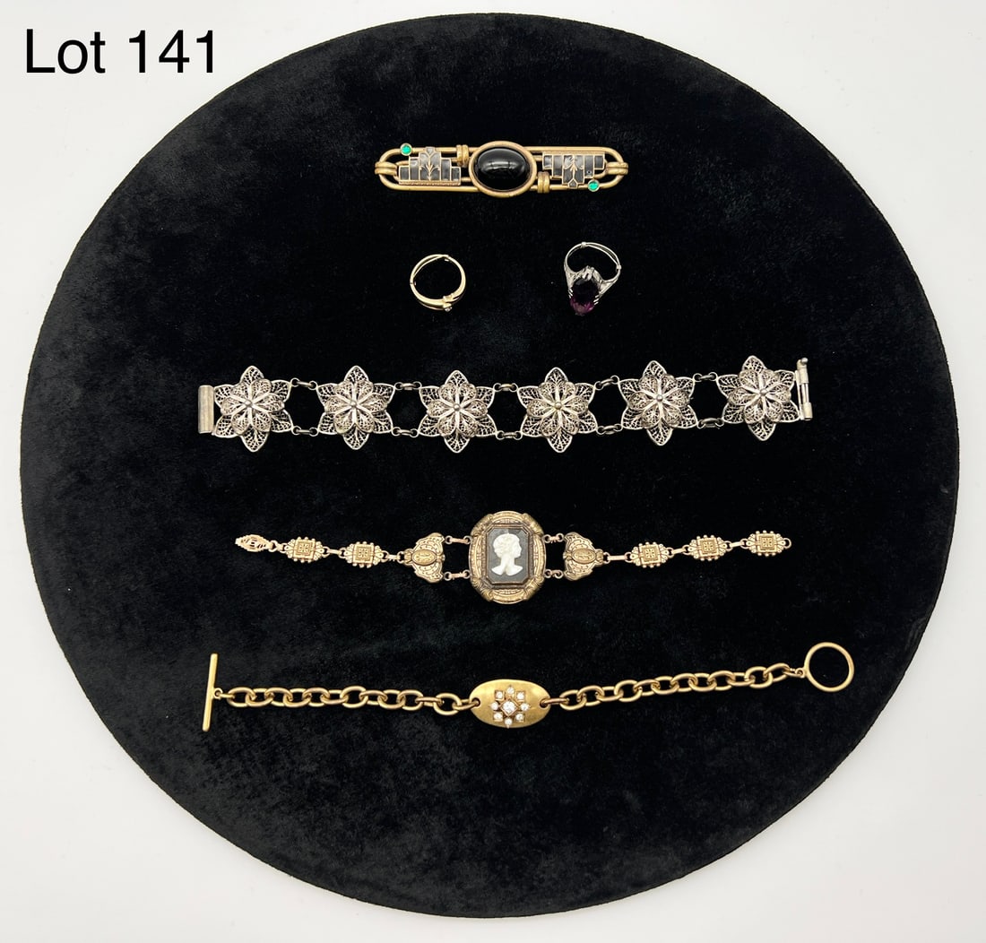 Selection of Antique and Vintage Costume Jewelry: A fine collection of antique/vintage jewelry featuring art deco styles. Includes a gold tone cameo bracelet, a gold tone bar brooch with black cabochon center stone and green accent stones, a silver t