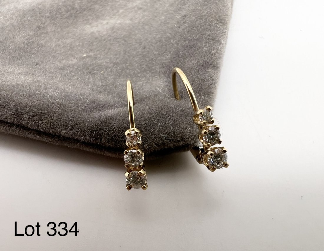 14K Gold Diamond Earrings: A pair of 14K yellow gold diamond clip on earrings. .27 ct diamonds. Total weight is 0.55 dwt.