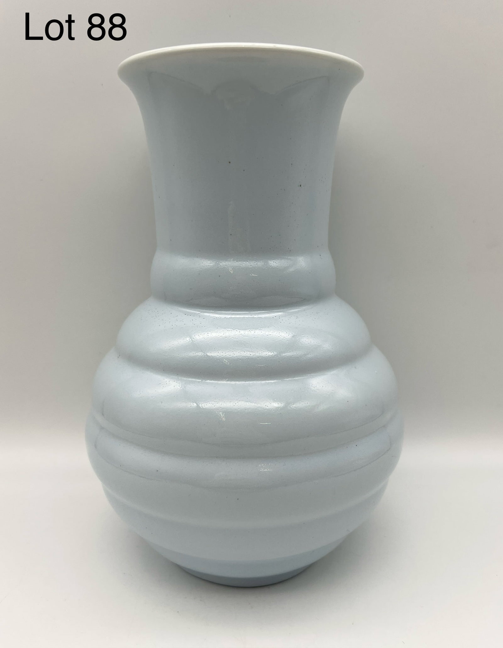 1935 Rookwood Ribbed Vase: A 1935 Rookwood pale blue gloss glaze vase with bulbous shape, fluted rim and ribbed body. Mold #6410, 9" tall. Makers marks on underside. *notes- a few glaze pops.