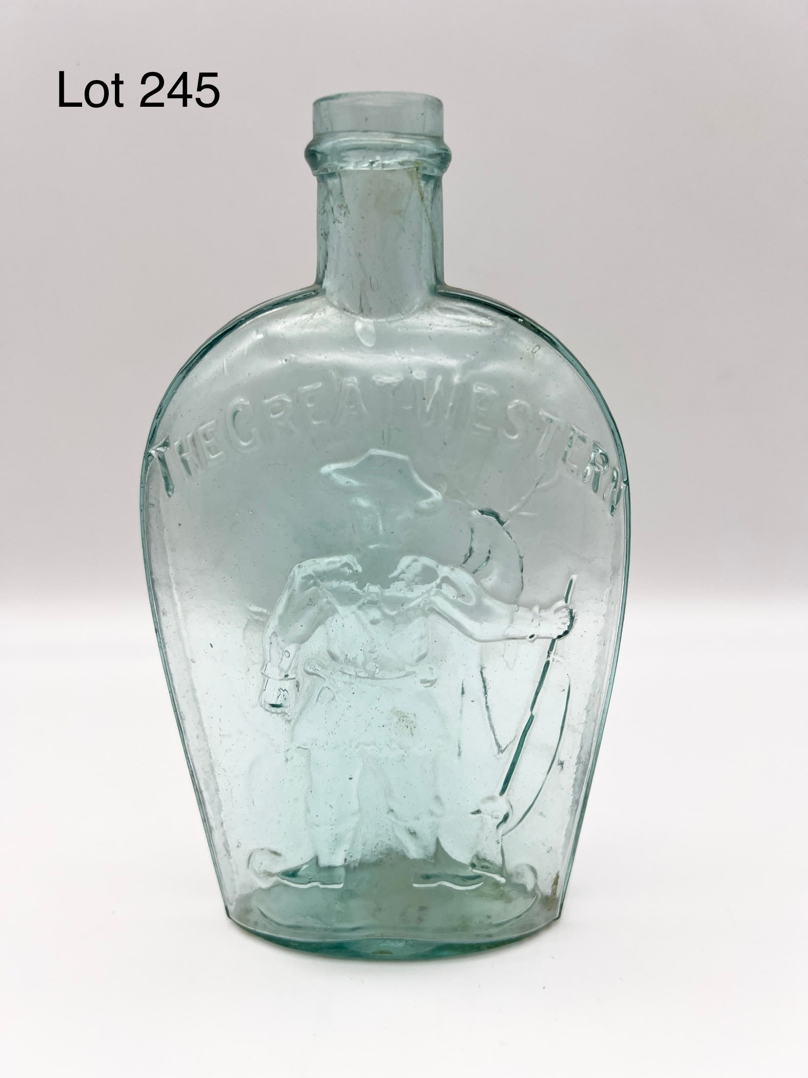 Antique Great Western Aquamarine Glass Flask Featuring Hunter and Stag Motif: Mid 19th century The Great Western aquamarine glass pint sized flask. This flask features a hunter with gun on front and a stag on the back. Stands 7 1/2" tall. *notes- small chip on mouth.