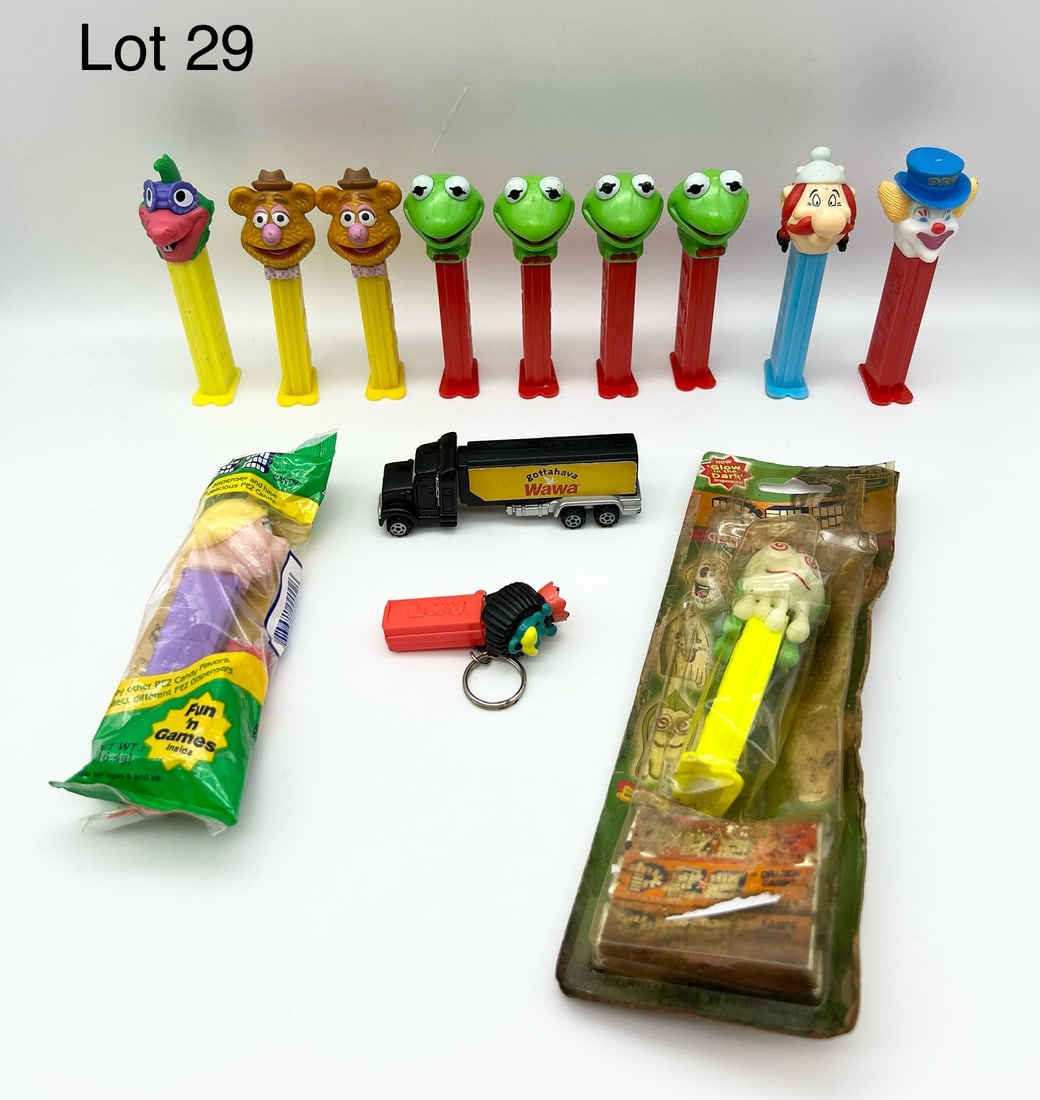 Lot of PEZ Dispensers Featuring The Muppets and More: A collection of 12 PEZ dispensers. Includes: 4 Kermit the Frog dispensers, all made in Hungary. 2 Fozzie Bear dispensers made in Austria. 1 Miss Piggy in original packaging. 1 clown made Slovenia. 1 d