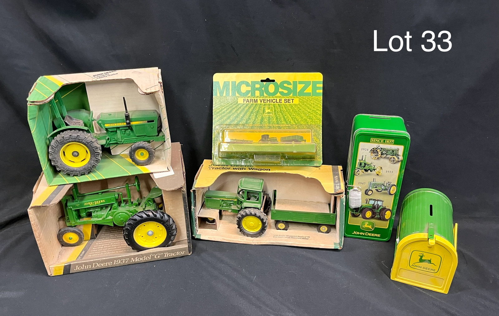 Mixed Lot of of John Deere Models and Collectibles: Six pieces of John Deere brand collectibles including three die cast models from Ertl. Models include a 1:16 scale 1937 Model "G" Tractor (stock #548), a 1:16 scale Compact Utility Tractor (stock #581