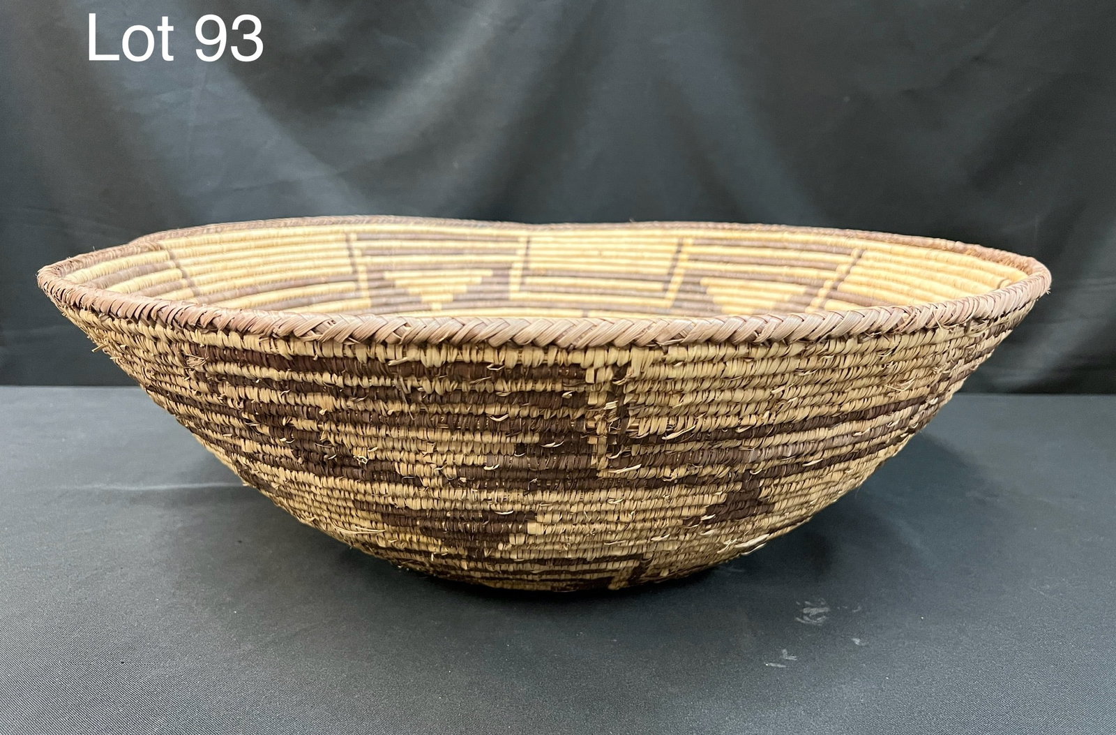 Large Tribal Basket: A large sized, split palm leaf coiled basket with bold geometric design elements. 24" x 8"