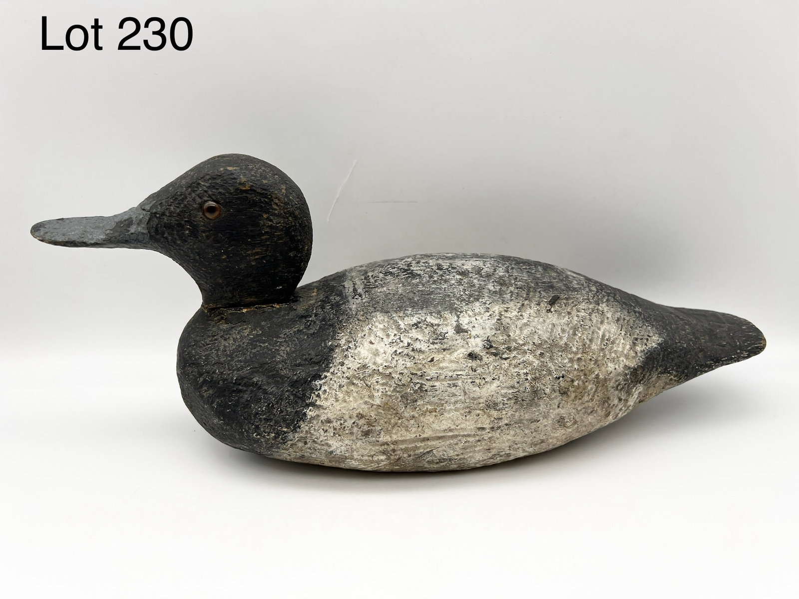Greater Scaup Drake Decoy: A Greater Scaup drake duck decoy with glass eyes. Measures 14" long. *notes- wear and paint loss throughout, crack on head