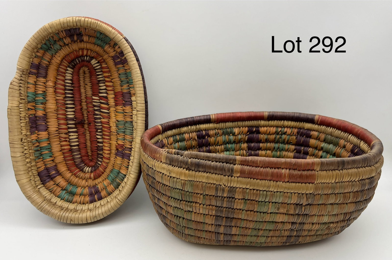 Early Coiled Basket w/ Lid: An early coiled basket with beautiful multicolor patterned weave. Oval form, very nice condition, measures 10 1/2" x 6"