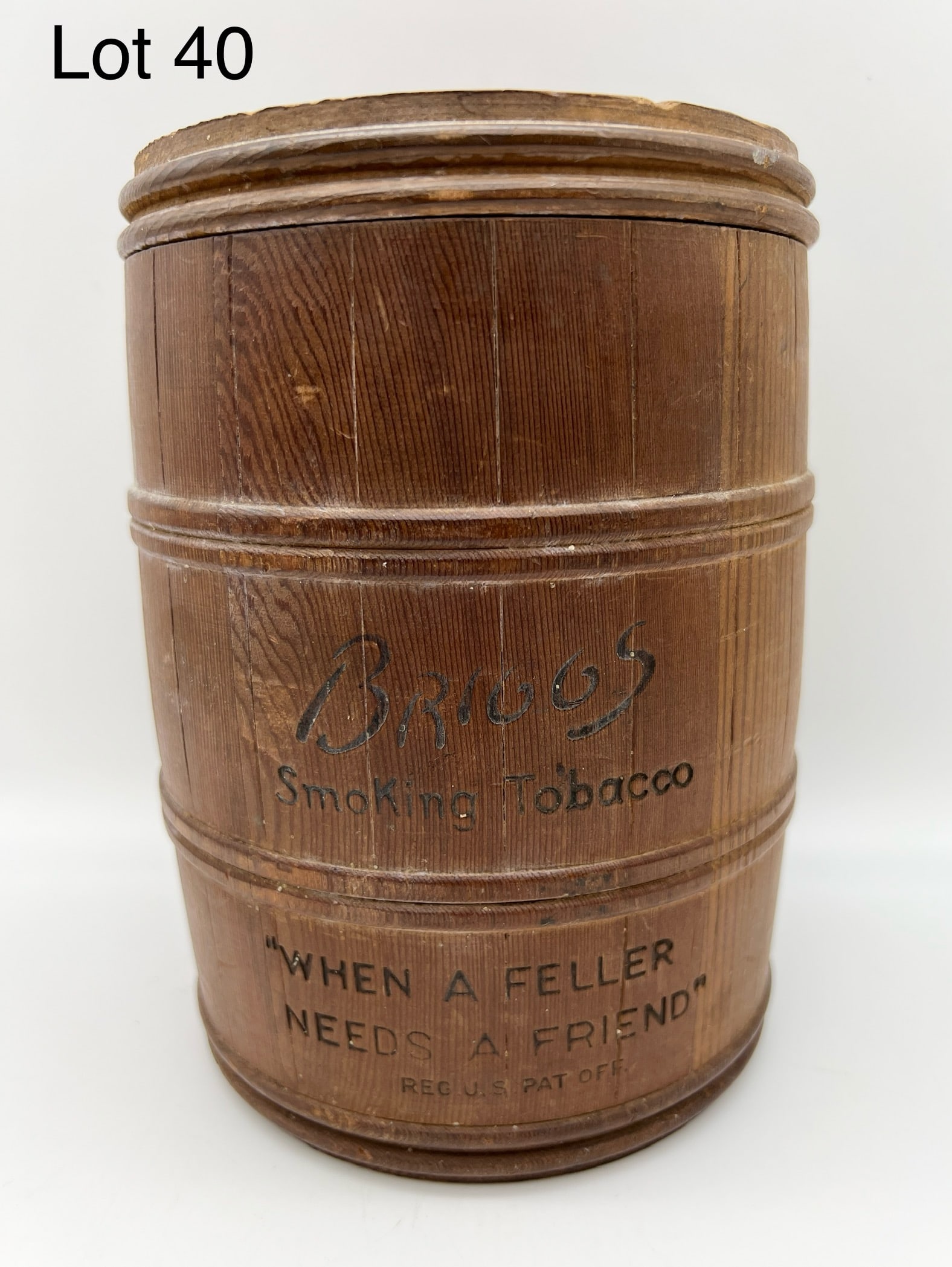 Early 20th Century Briggs Smoking Tobacco Barrel Shaped Humidor: 1930s Briggs Smoking Tobacco barrel shaped wood humidor. Reads "When a Feller Needs a Friend." below Briggs logo. Lid reads "Briggs Smoking Tobacco, Aged in the Wood." 7 1/4" tall. *notes- wear to woo