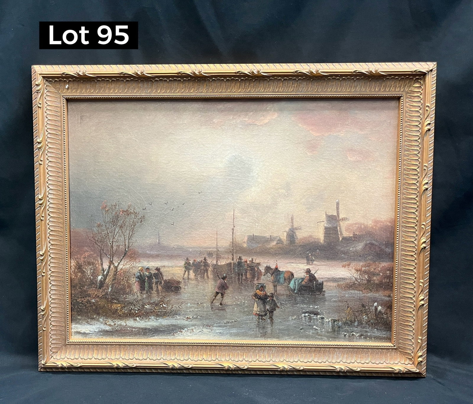 Antique Oil on Canvas of Dutch Ice Skating Scene: An antique oil on canvas of a scenic Dutch ice skating scene, with fisherman working in the lake as windmills turn in the sun's fading light. Vintage gilt frame, no artist signature noted. Measures 22