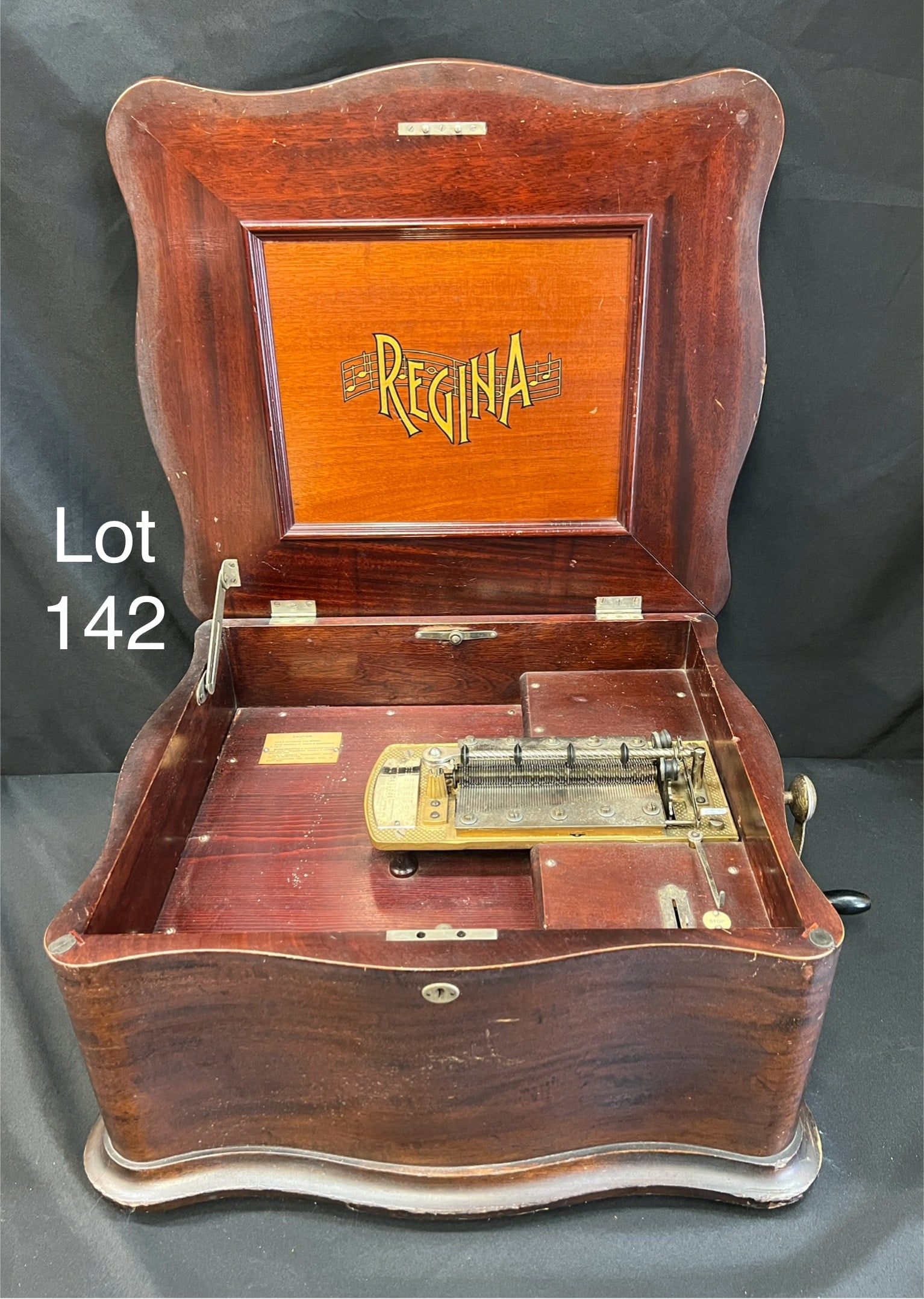 Antique Regina 15 1/2" Music Box Model 50, Serpentine with 30 discs: A turn of the century Regina mahogany 15 1/2" music box. Model 50, Serpentine case. Marked no. 5001132. Measures 21" x 10 1/2" x 19". Comes with 30 discs. *notes- wear to wood from age. **PICK UP ONLY