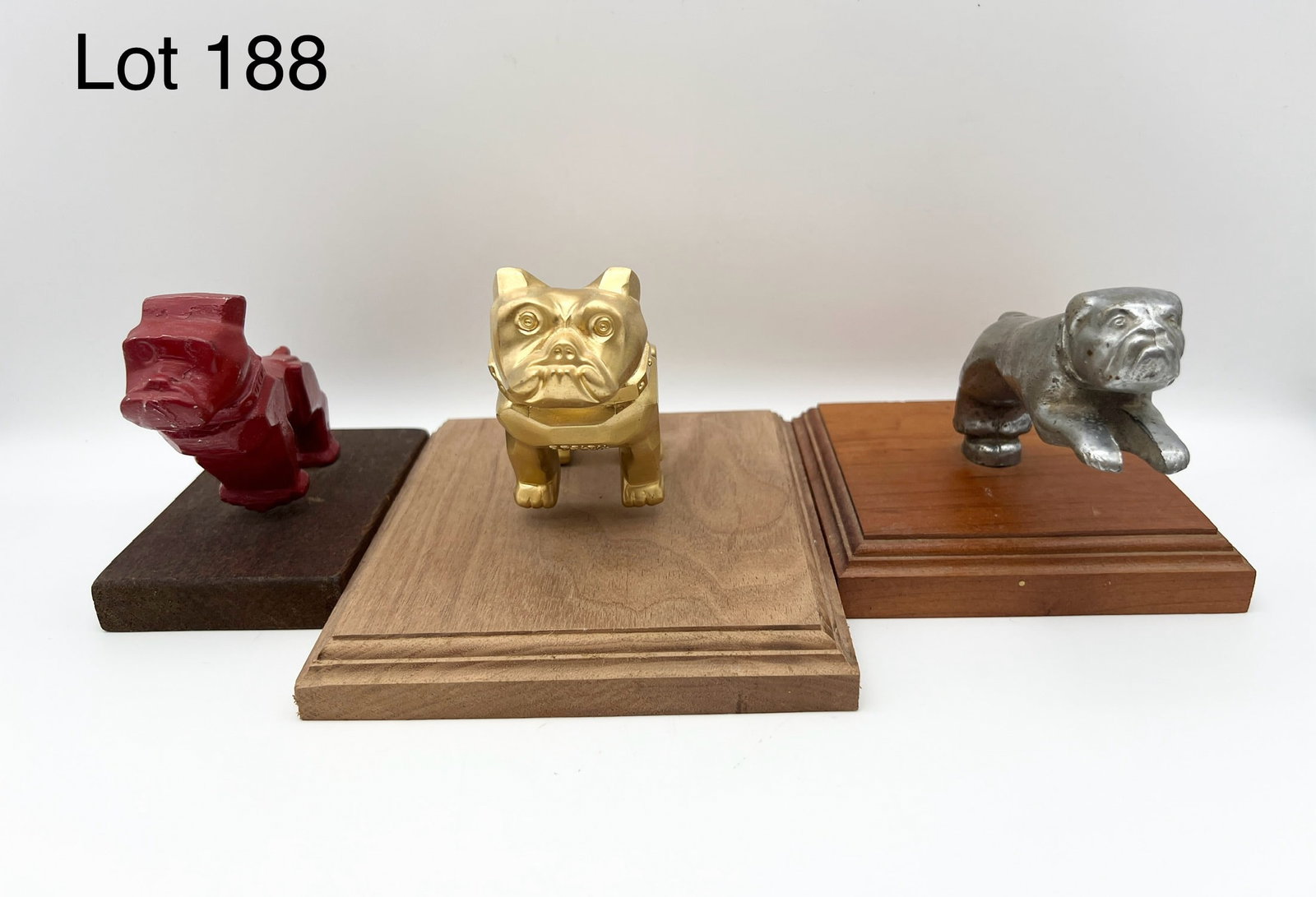 Group of Mack Truck Bulldog Hood Ornaments: Lot of three Mack Truck Bulldog hood ornaments. All mounted on to wood bases.