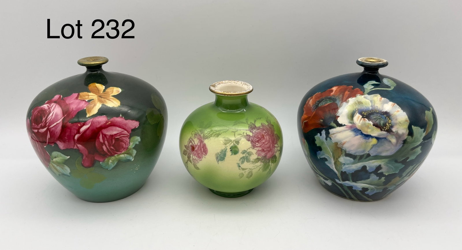 Trio of Antique Floral Bud Vases: A lot of three antique floral bud vases. Two are a matching pair of German Royal Bonn vases with thin gilt lids, shown blue and green. The third is a smaller rose decorated bud vase, makers marks at b