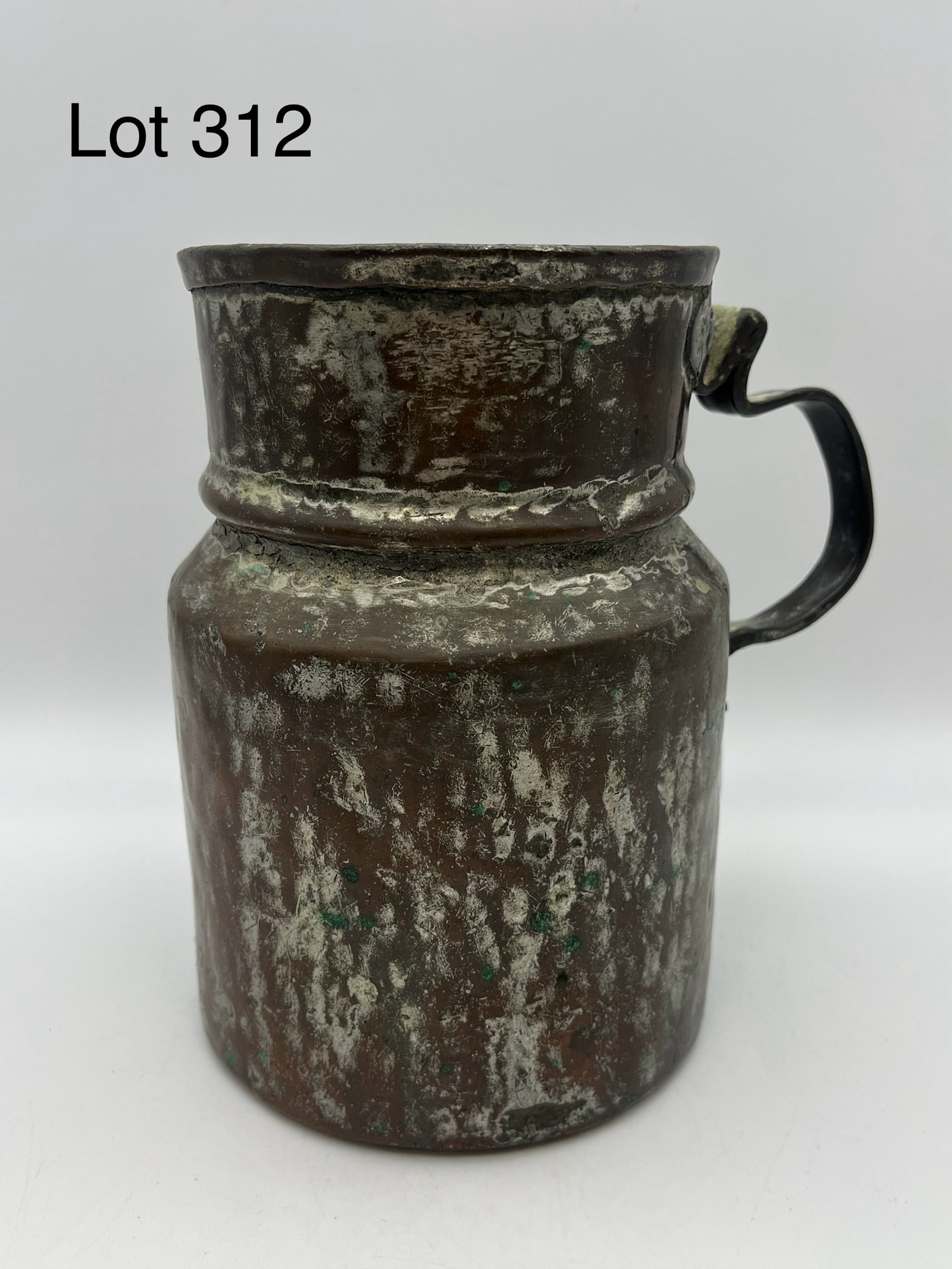 Antique Copper & Tin Pitcher: A rustic 19th c. hand forged copper over tin pitcher or jug. Crimped handle, intricately made dovetailed base. Measures 7 1/4" tall. *note - patina