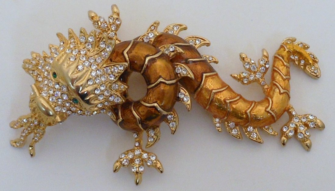 Large Oriental Dragon Costume Brooch: 4 1/2" long X 2 3/4" wide, gold colored Dragon brooch adorned with faceted glass and green eyes, unmarked, great condition.