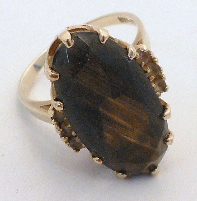 10Kt Gold Topaz Ring: 10Kt yellow gold topaz ring with a large oval center stone, six side stones?, all in a basket setting, size 7, marked 10KP, great condition.