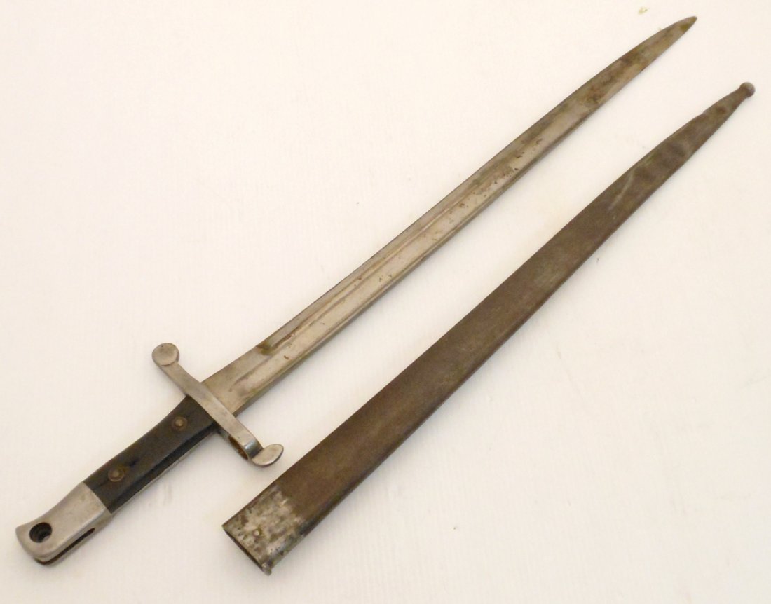 Portuguese Kropatschek Model 1885 Sword Bayonet Austria: 23 1/2" total with a 18 3/8" blade, Portuguese Kropatschek bayonet, manufactured by Steyr in Austria, partly visible mark 'Steyr 1886' on the spine, missing the locking button, crack in one of the gri