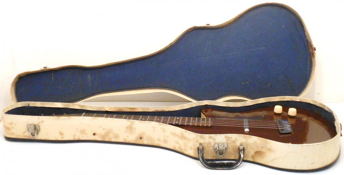Silvertone 1960 Danelectro U-1 Electric Guitar W/Case: 37" X 12 1/2". Appears to be all original. The action is low and comfortable with new strings. Well played with scratches, paint loss on back, pegs are slightly rusted, pick guard is warped. Includes 