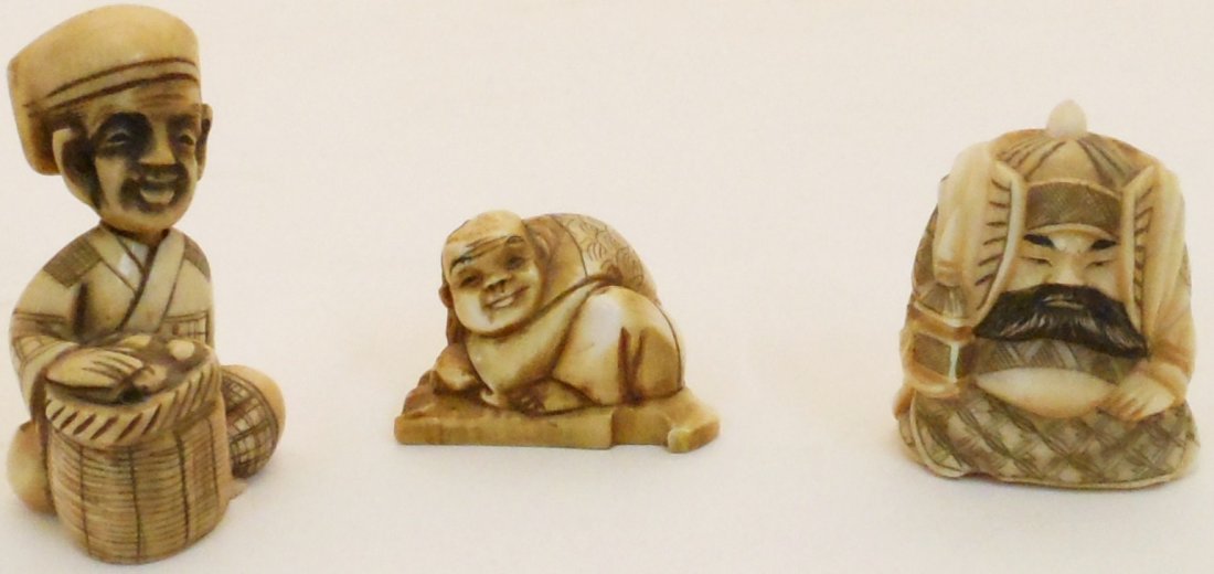 Lot of 3 Chinese Hand-Carved Netsukes: Tallest Netsuke is approx 1 3/4” tall . Mid Century. One is a bobble-head design with a moveable head of a man sitting with a basket in his lap. Signed and in Great Condition. One is of a man posing