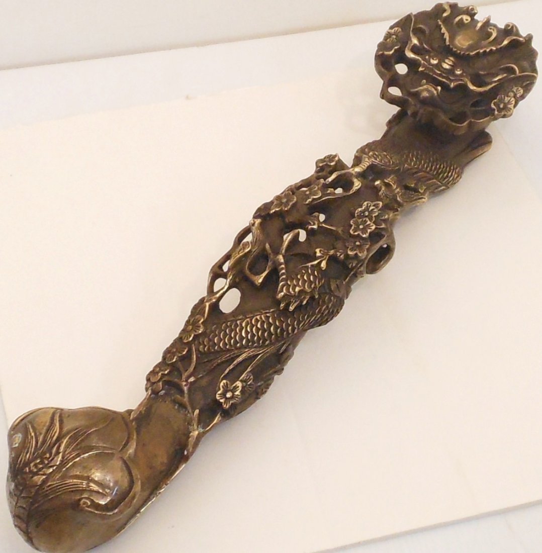 Bronze Dragon Ruyi Scepter: 14 1/2" long X 4" wide X 3 1/4" deep, China, solid bronze Ruyi with a Dragon, its face is the upper section, the body that wraps around the shaft, and the tail ends on the lower section, there are als