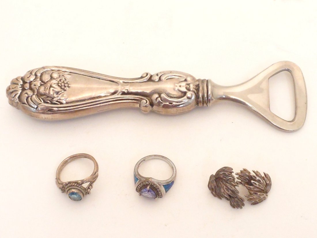 Lot of Sterling Jewelry and Sterling Bottle Opener: Sterling Silver Handled Bottle Opener. Two Sterling Silver Rings. One Pair of Sterling Silver Earrings. Great Condition.