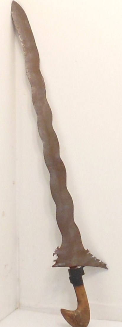 Vintage Kris Sword: 27 1/2" total with a 22 1/4" blade. Kris or keris is an asymmetrical dagger most strongly associated with the culture of Indonesia, but also indigenous to Malaysia, Thailand and Brunei. The kris is fa