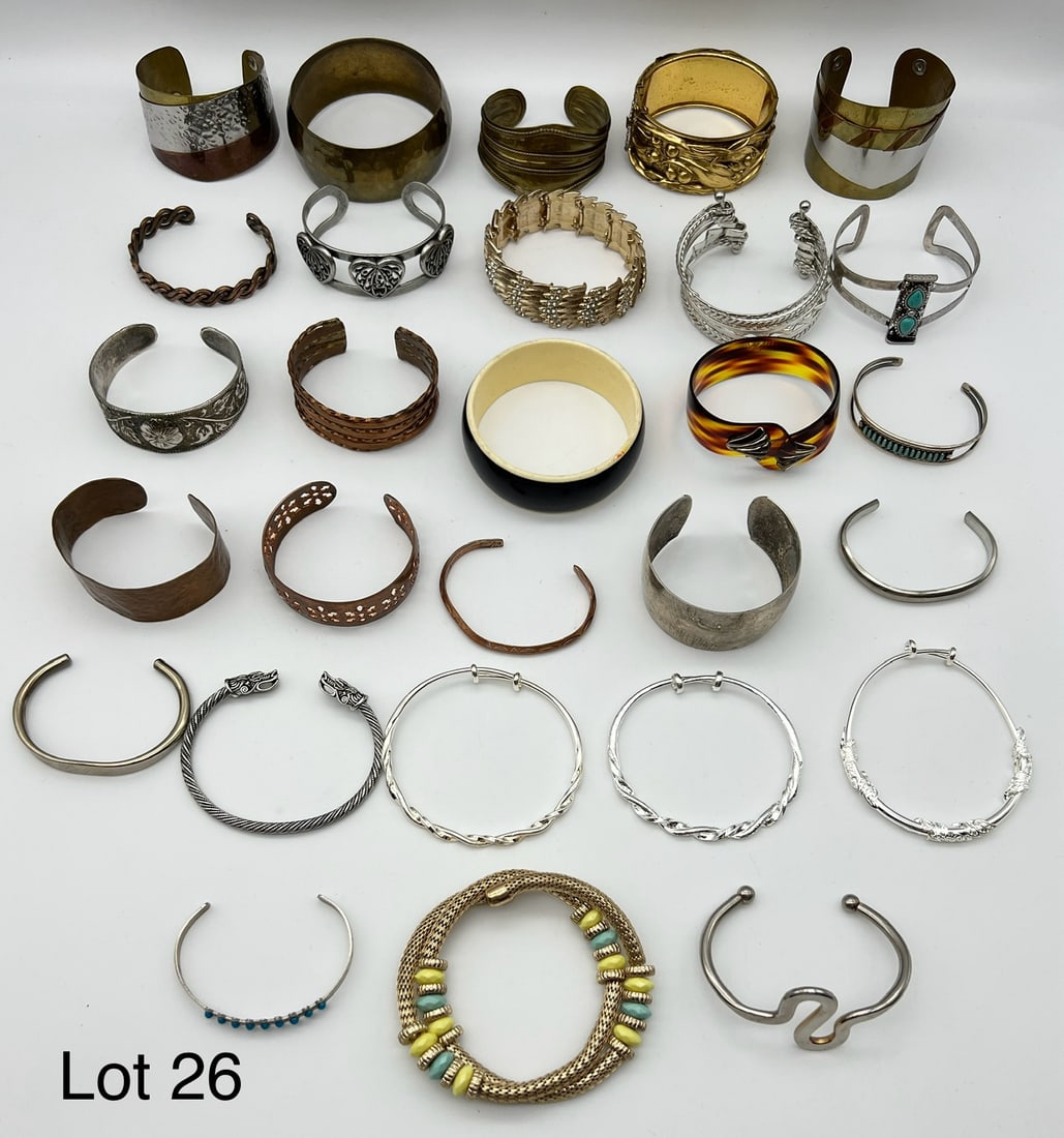 Lot of Costume Bangle and Cuff Bracelets: A group of costume bangle and cuff bracelets. Includes a mix of metals, acrylic, beads and stones.