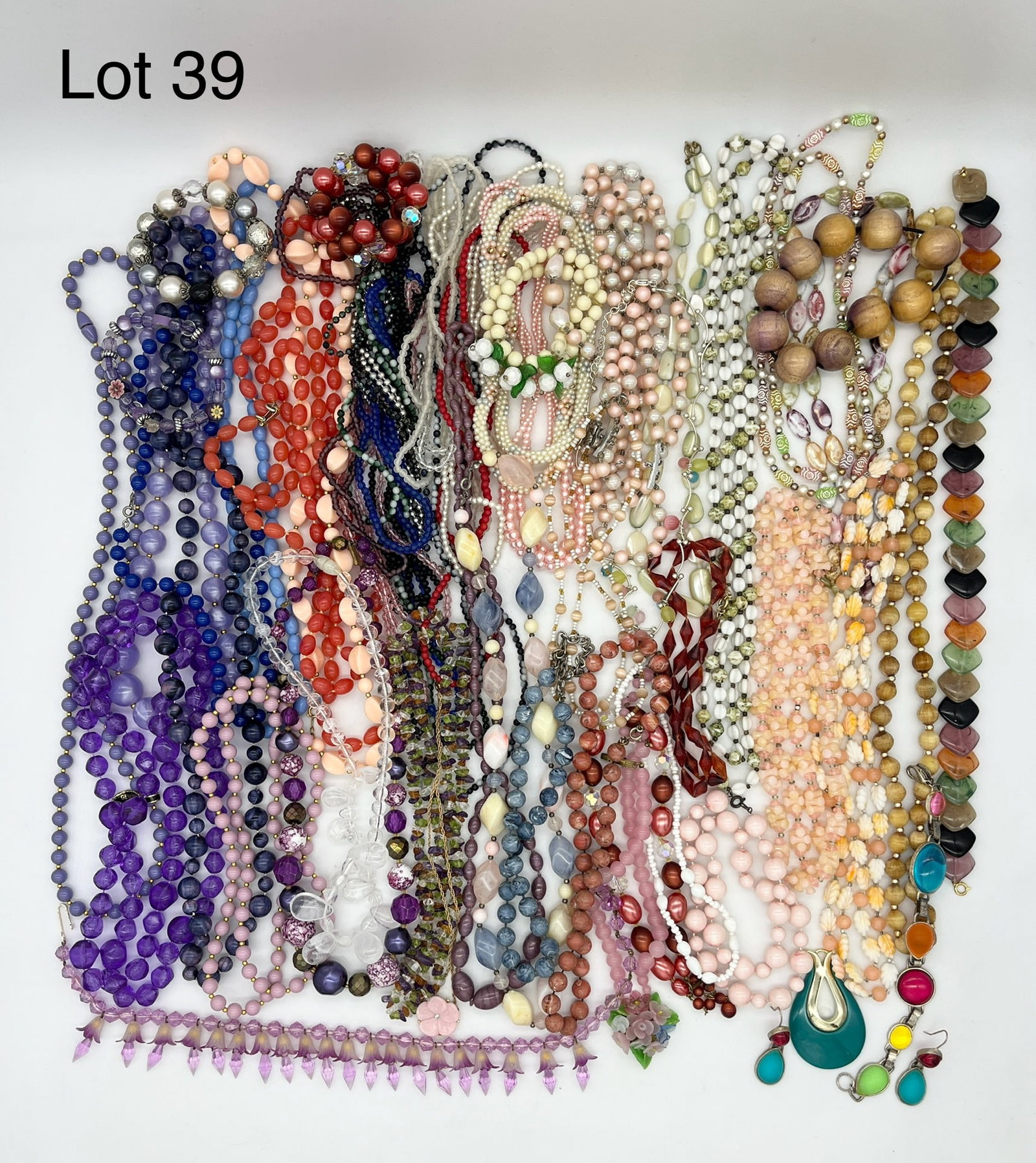 Variety of Costume Jewelry Beads: Variety of costume jewelry beads in mixed materials. Mostly necklaces but also shows bracelets, pendants, and earrings.