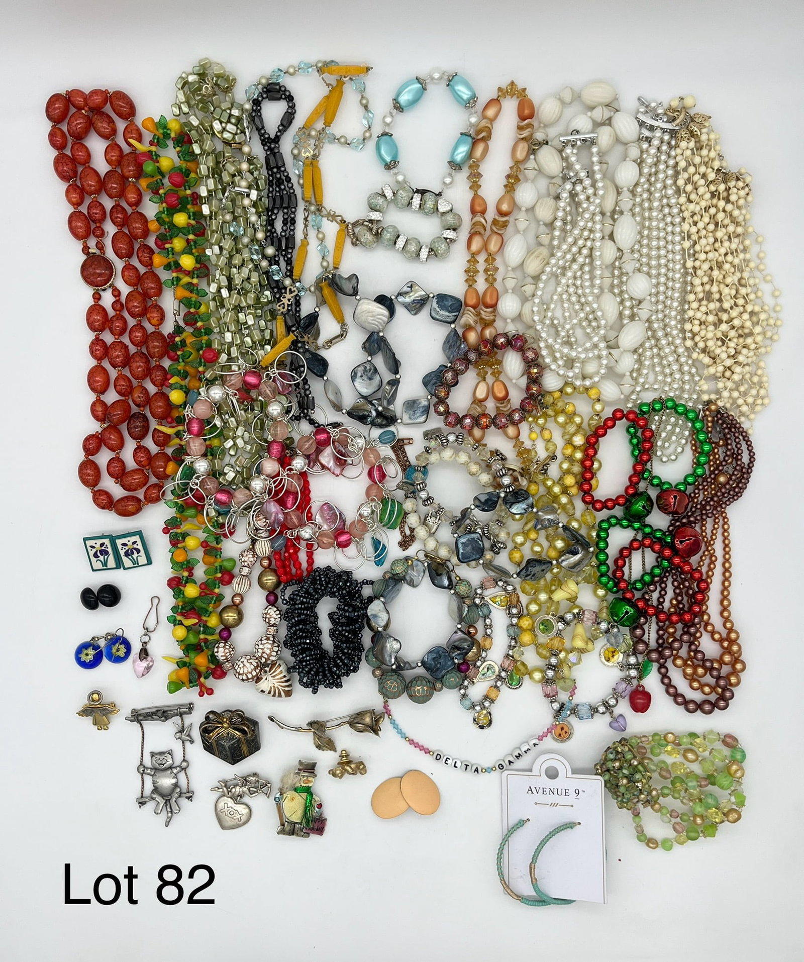 Lot of Costume Jewelry Featuring Colorful Beads: A mixed lot of costume jewelry with a focus on unique and colorful beads. Also includes earrings and brooches, many of which are signed from designers like Best and JJ.