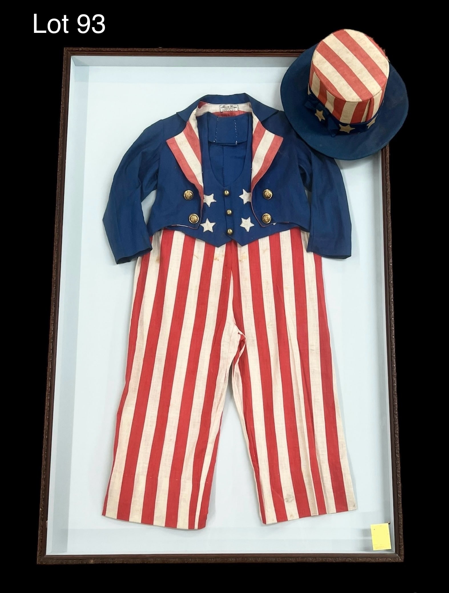 1930s Child Size Uncle Sam Parade Costume: A 1930s Uncle Sam child size parade costume presented in a large showcase frame. Includes top hat. Sold by Skeets Mayo Costumes, Nashville, Tennessee. Frame measures 46 1/4" x 30". ***PICK UP ONLY***