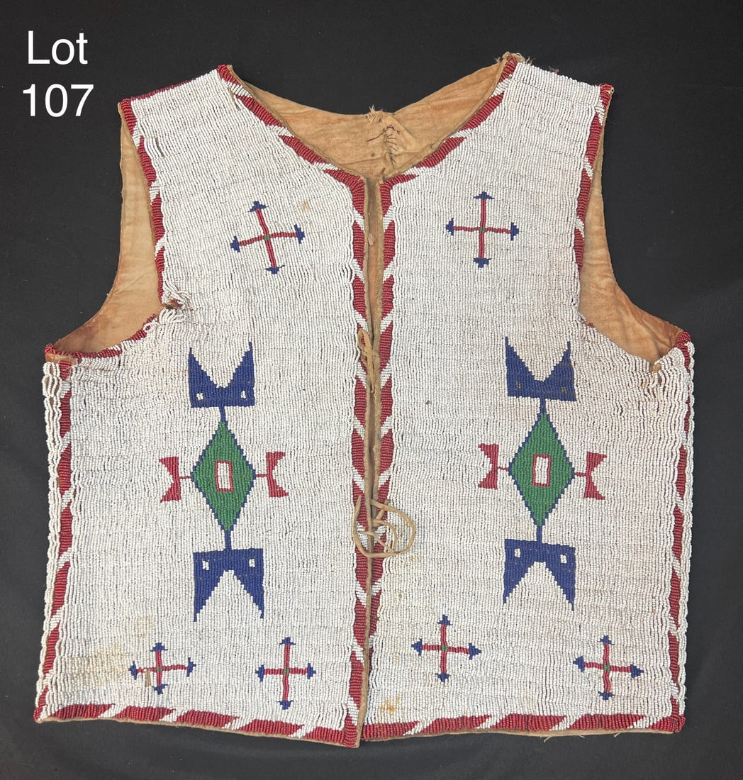 19th Century Sioux Indian Beaded Vest: A ca. 1890 Sioux Indian, fully beaded vest. This item is sinew-sewn on Indian tanned hide, muslin lined with very minor bead loss at the arm opening.