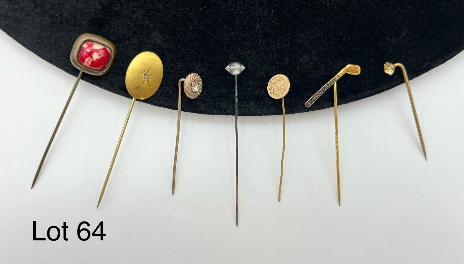 Group of Vintage/Antique Stick Pins: A group of seven vintage/antique stick pins. Includes a Brynwood Golf Club, a mottled red stone, and a leaf coin