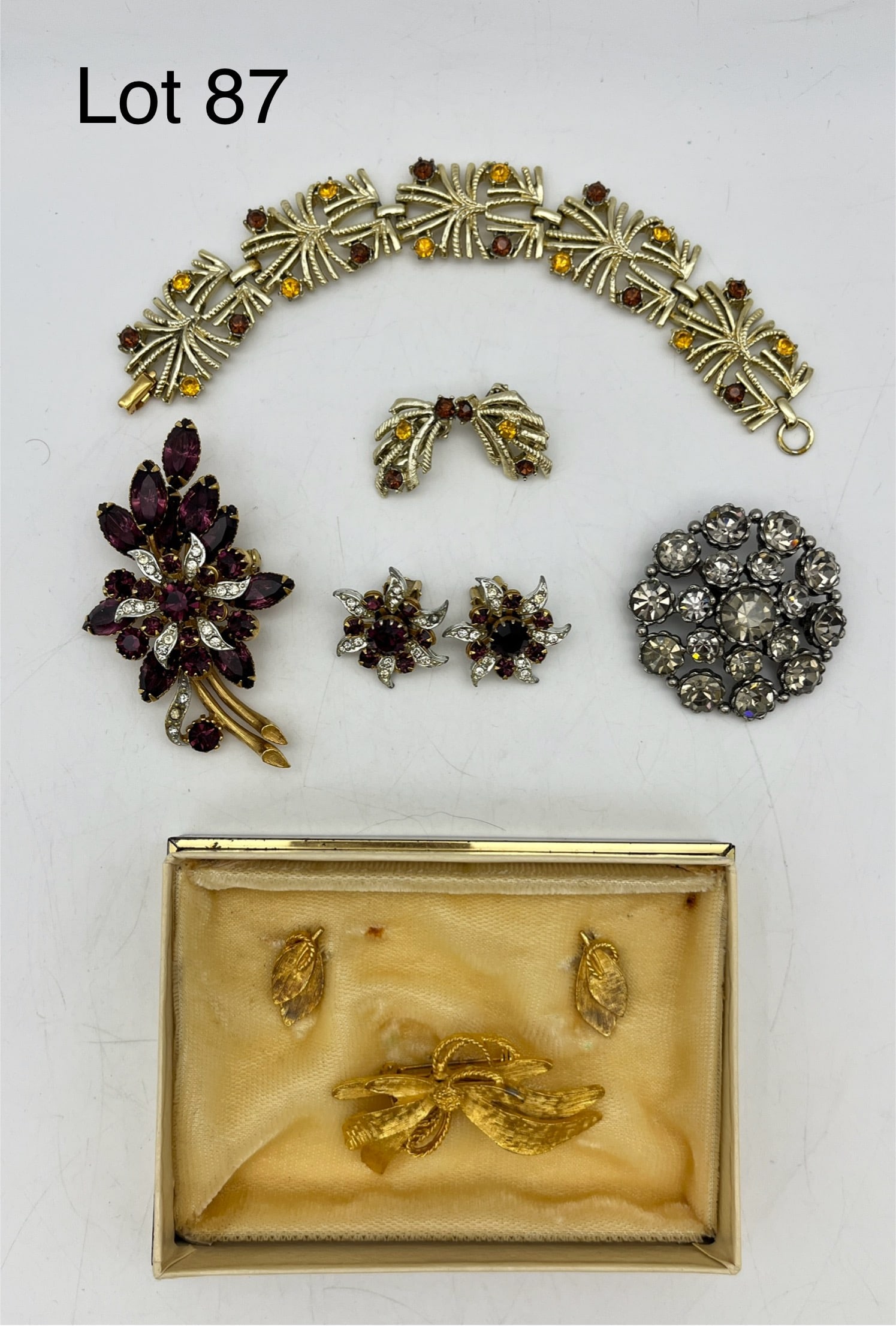 Vintage Costume Jewelry Sets: A dazzling lot of vintage costume jewelry sets. Includes a brooch/earring set in gold, a red crystal rhinestone brooch/earring set, a Coro rhinestone bracelet/earring set. Also shows a crystal brooch