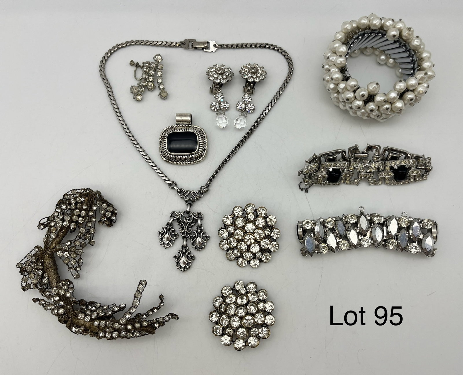 Selection of Vintage Rhinestone Costume Jewelry: A selection of vintage costume jewelry showing silver tones and rhinestones. Includes a Barclay pendant necklace, a rhinestone branch, and more.