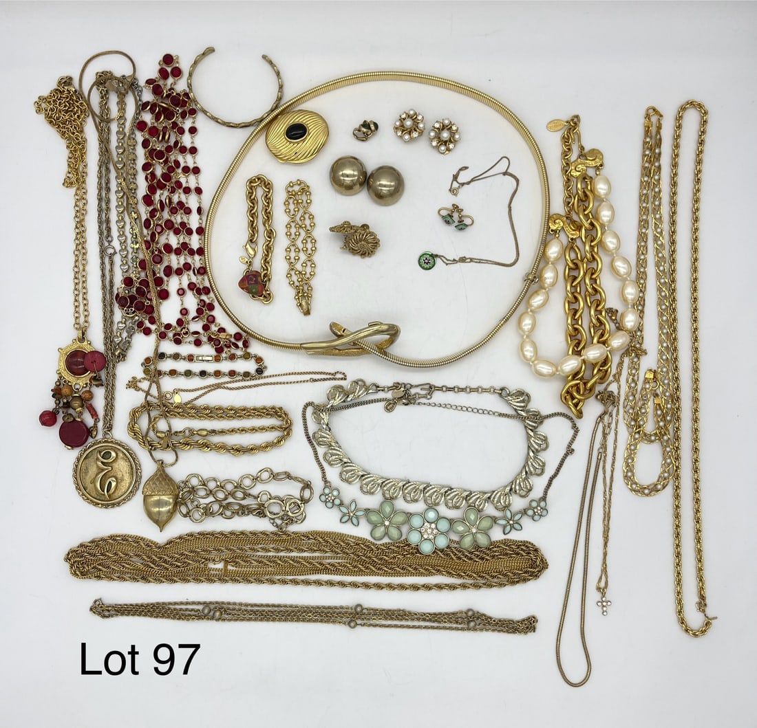 Signed Costume Jewelry Lot in Gold Tones: A lot of signed costume jewelry in gold tones showing necklaces, bracelets, and earrings. Includes designers like Coro, Monet, Lisner, Avon, and more.