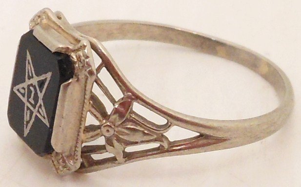 Woman's 10 kt White Gold Eastern Star Ring: 10 kt white gold Masonic eastern star woman's ring with a black onyx base. Size 8 1/2. Good condition missing one star point insert.