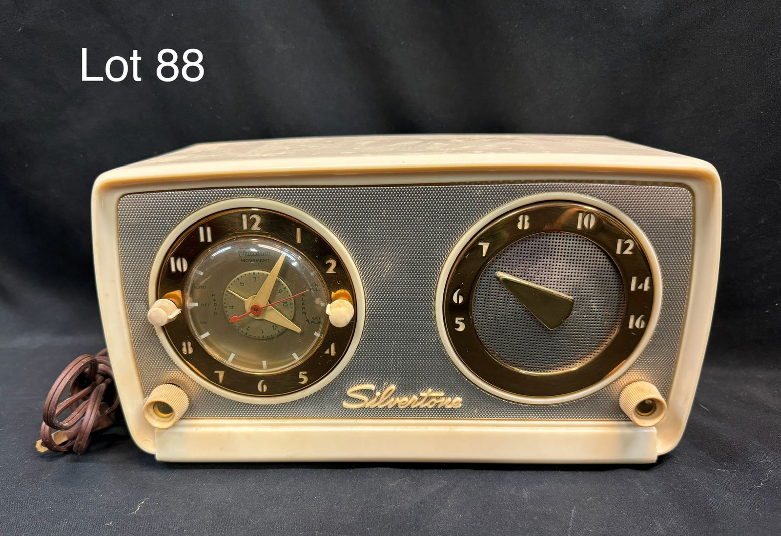 Silvertone (Model 10/3026?) Tube Clock Radio: A Silvertone model 3026 tube clock radio. Ivory tone, clock shown on left with circular radio dial on right with gilt accent, 4 knobs.