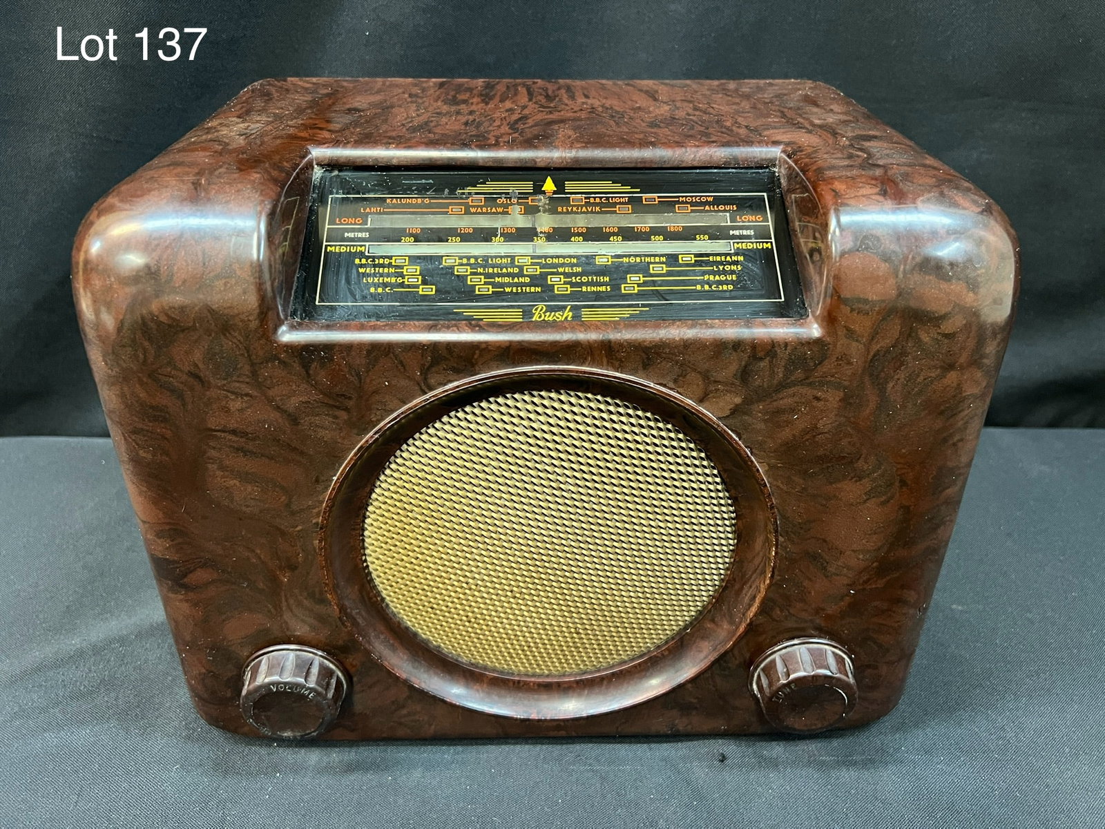 1948 Bush DAC90A Bakelite Tube Radio: A 1948 Bush DAC90A tube radio with brown bakelite case and woven speaker grill. Two knobs, top center slide dial. AC/DC.