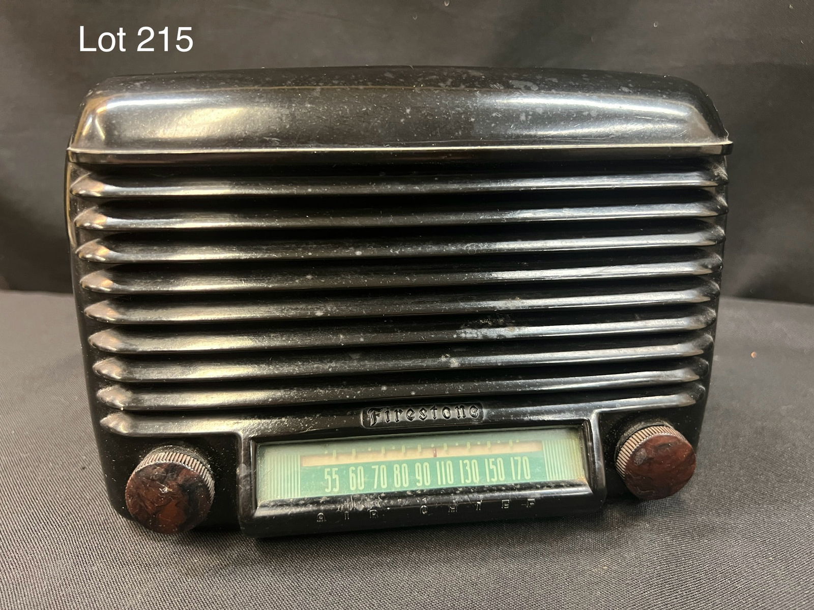 1940 Firestone S-7402-7 Air Chief Tube Radio: A 1940 Firestone S-7402-7 Air Chief tube radio. Black table top plastic radio with Firestone logo above dial.