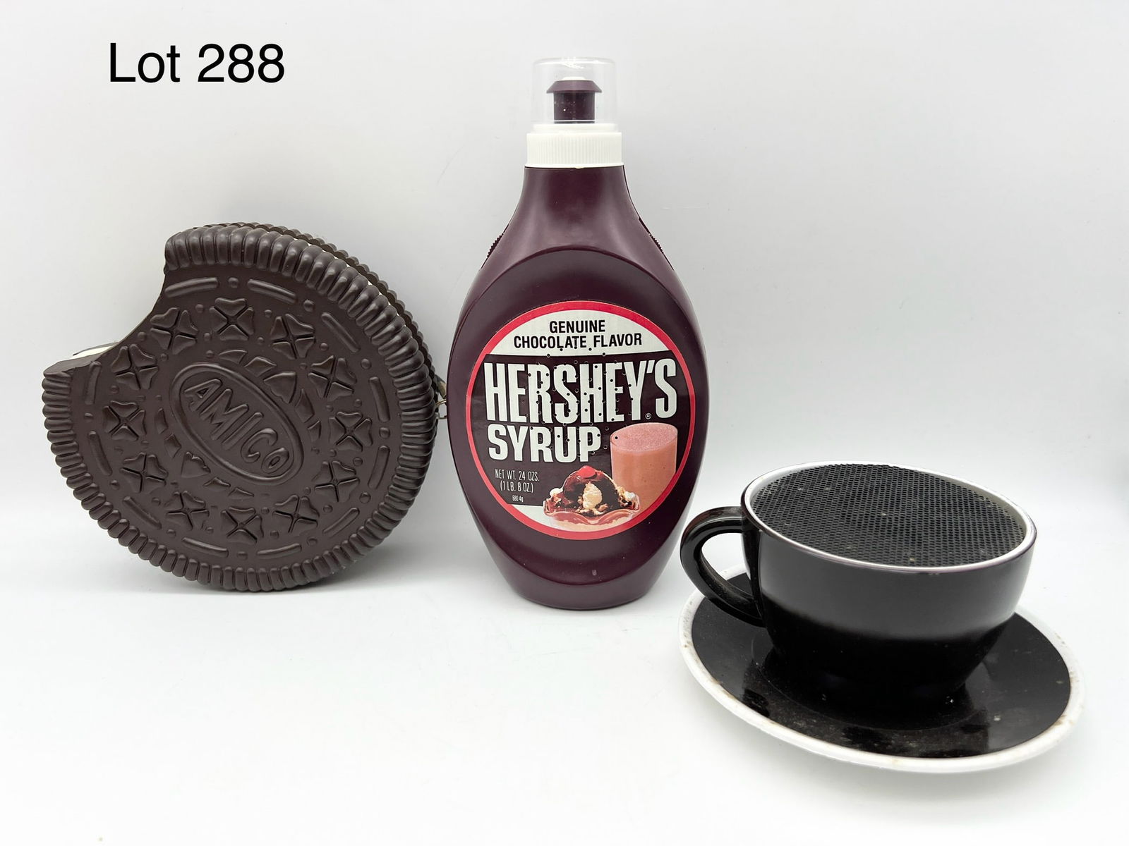 Trio of Novelty Transistor Radios: A group of three novelty transistor radios. Includes a Hershey syrup bottle, an Amico cookie (Oreo style) and a black tea cup.